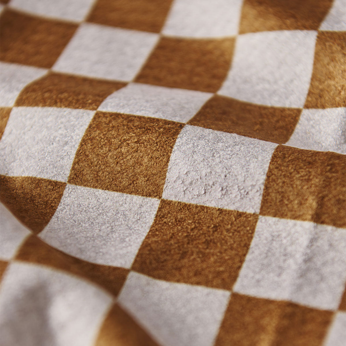 Beach towel with brown and white checkered pattern, soft woven fabric.