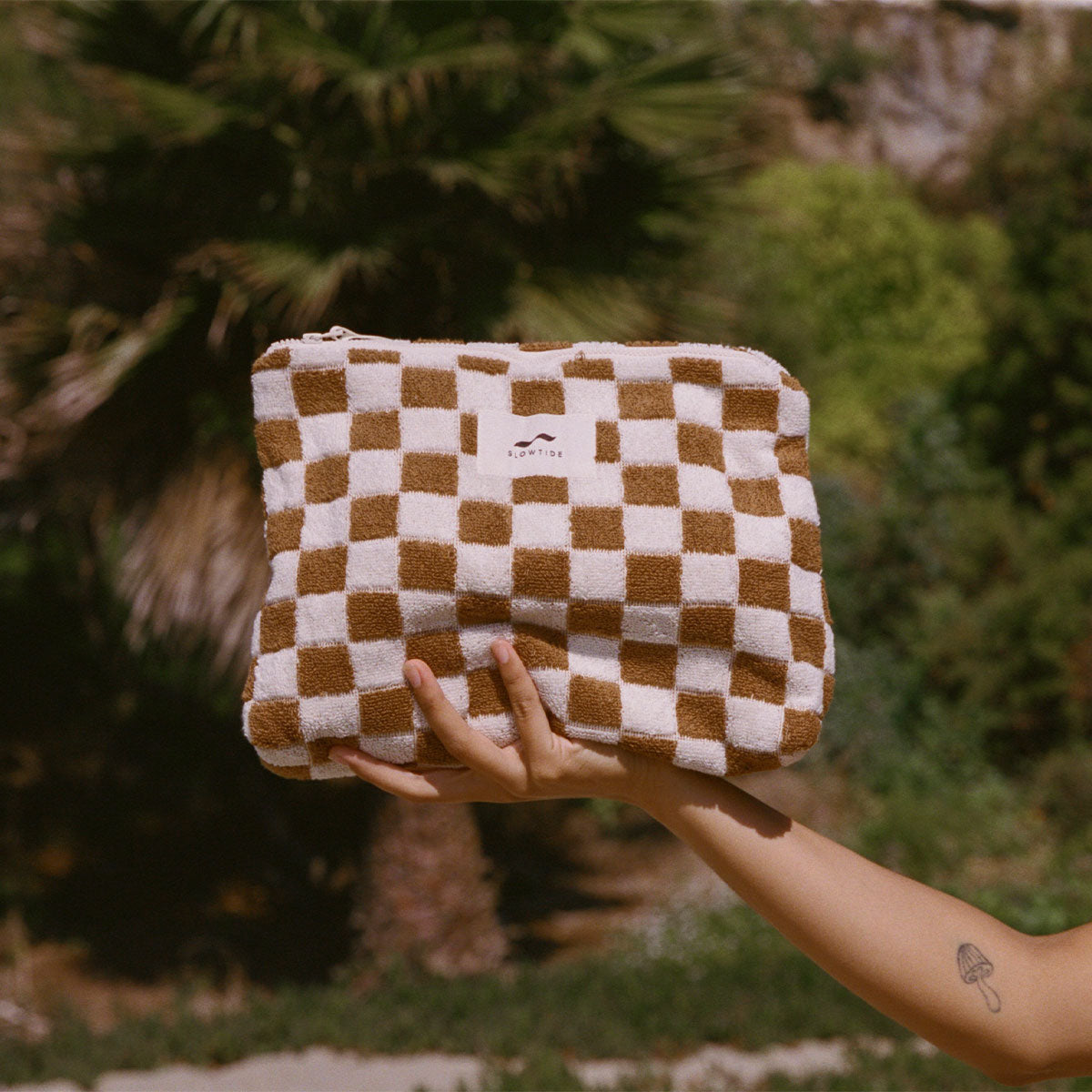 Terry pouch in brown and white checkered towel fabric with zipper.