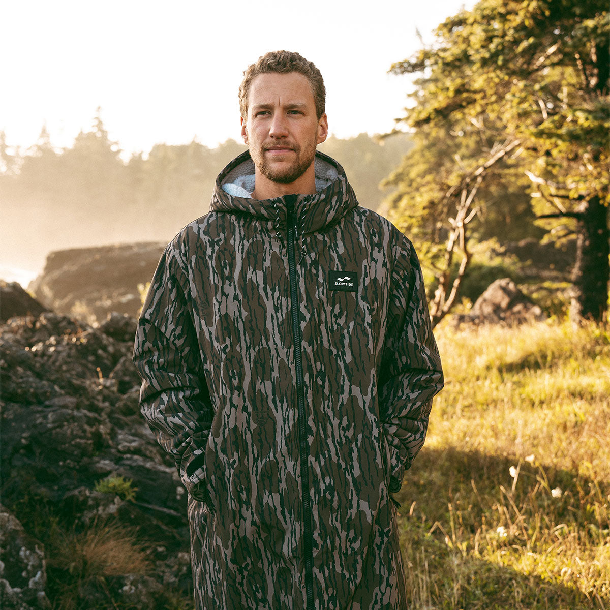 Camo-patterned all-weather jacket outdoors.