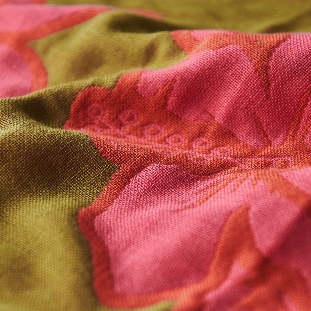 Beach towel with pink floral pattern, sand-resistant fabric, textured surface.