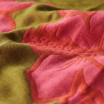 Beach towel with pink floral pattern, sand-resistant fabric, textured surface.
