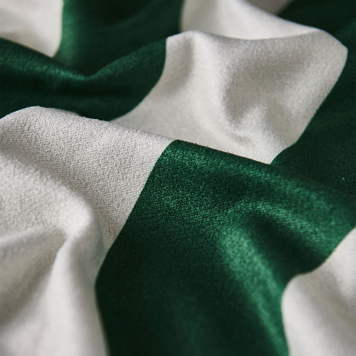 Towel, lightweight fabric with green and white stripes, visible texture and folds.