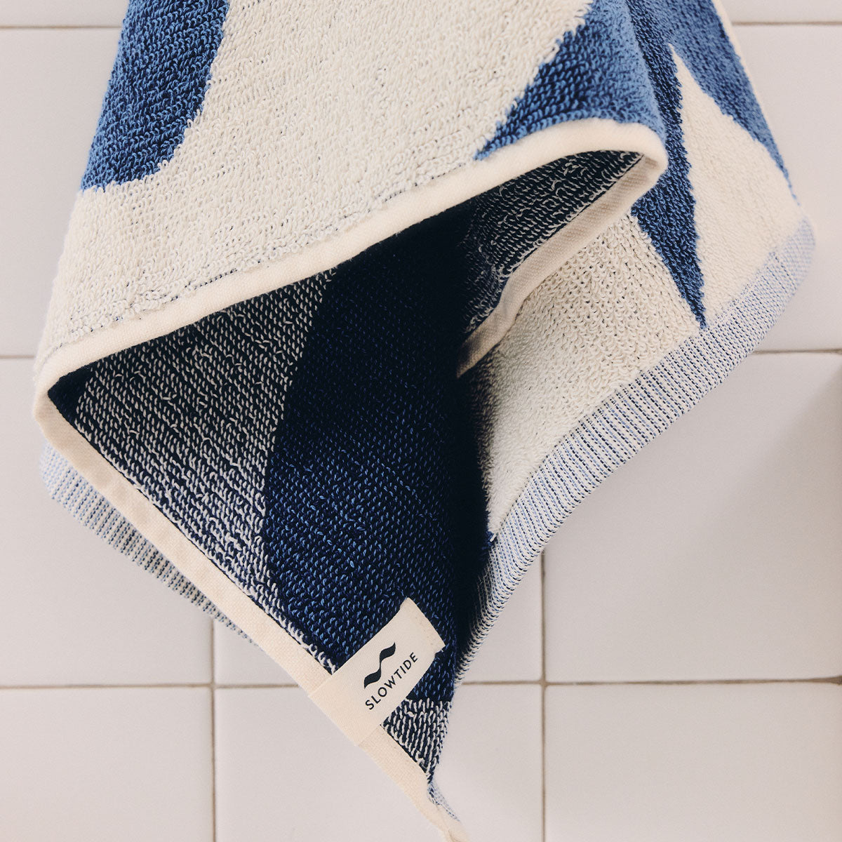 Cotton beach towel in indigo and white geometric pattern.