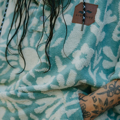 Towel poncho hoodie in blue and white floral pattern.