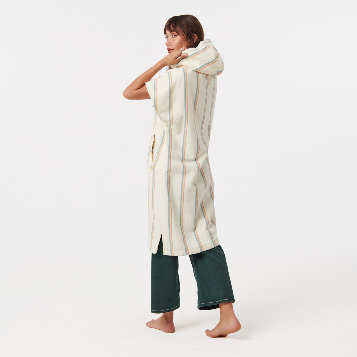 Hooded striped fouta robe with green pants.