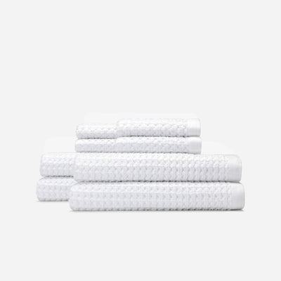 Cotton towels with textured finish, neatly stacked.