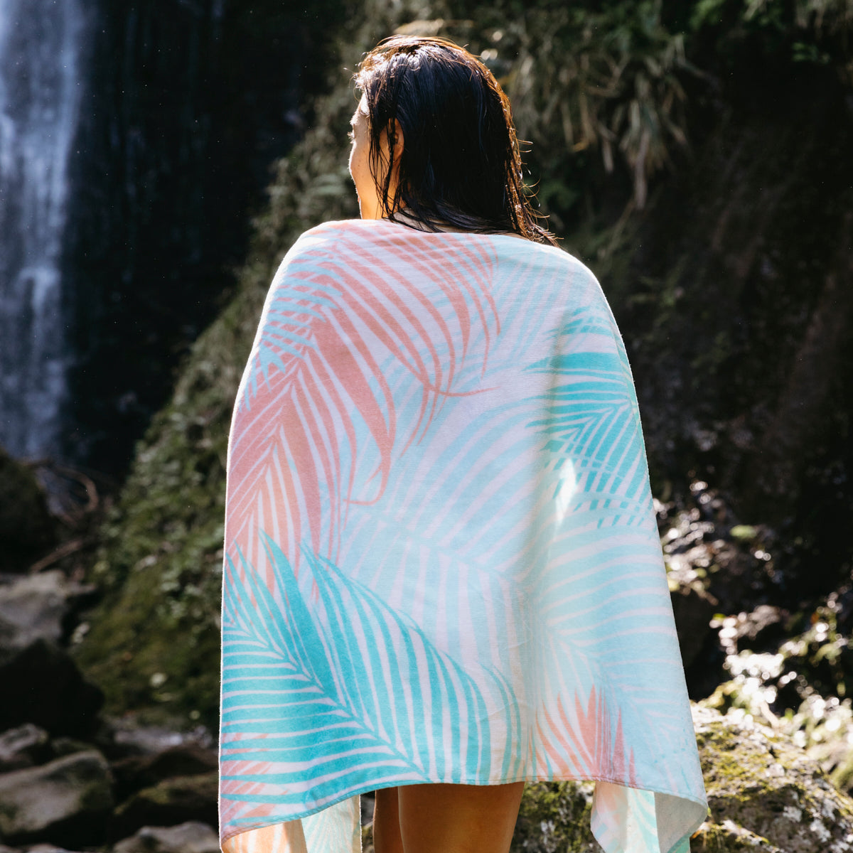 Beach towel, sustainable material, pastel palm-leaf print.