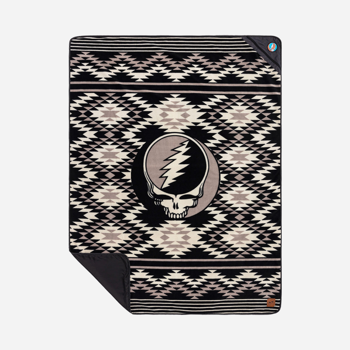 Sand free blanket with black and white skull and lightning bolt design.