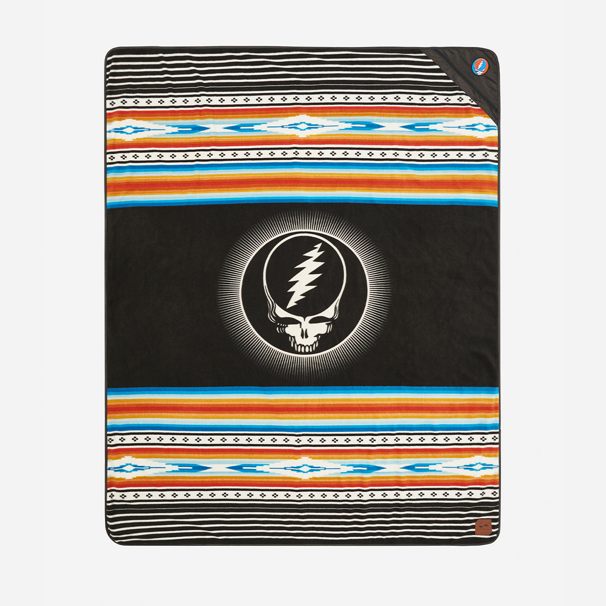 Water-repellent blanket with skull and lightning bolt, blue and orange geometric stripes.